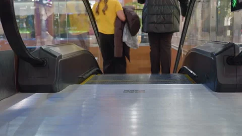 People Stepping Off Escalator Inside Mall From Back View Stock Footage 319918640