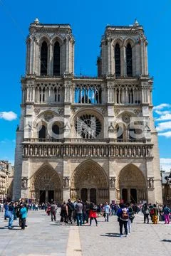 People on the street before the Notre Dame Cathedral in Paris Stock Photos