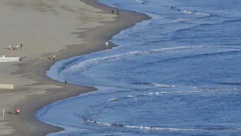 People strolling on the beach with waves Stock Footage 172395686