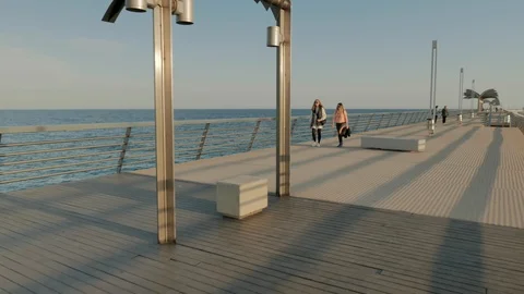 People strolling on the jetty of the dock Video stock 104670014