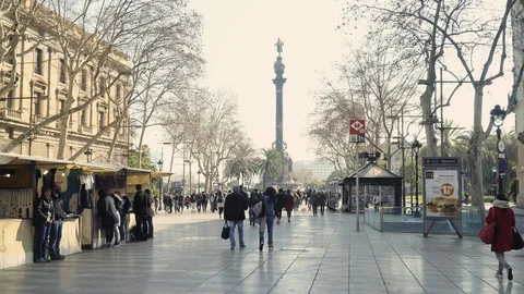 People strolling in Les Rambles with the Columbus Monument in the distance Stock Footage 102836539