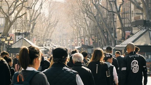 People strolling by Les Rambles in winter Stock Footage 102836624