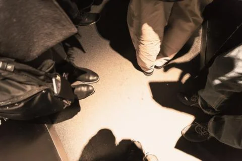 People stuck in a narrow elevator in the backlight. Stock Photos