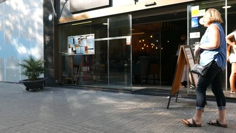People study menu in european cafe and go inside Stock Footage 94960637