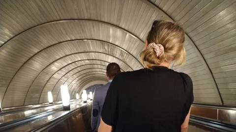 People on the subway are going down in an escalator Stock Footage 114358482
