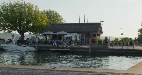 People in a summer cafe on the pier by the lake, Switzerland, Staffa Stock Footage 200301933