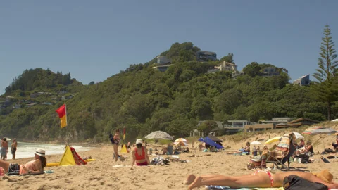 People sunbathe on beach Stock Footage 247692227