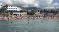 People sunbathing and swimming in Coral bay, Peyia, Paphos, Cyprus HD Footage
