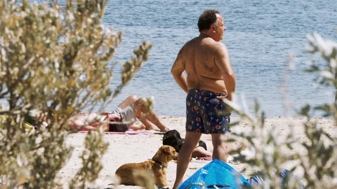 People sunbathing in a beach Stock Footage 82551690