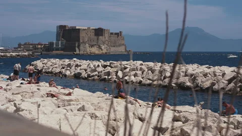 People sunbathing on the cliff of the Napoli's seafront Video stock 279486393
