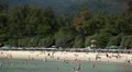People sunbathing near the beach, relaxation, resort, sand, shoreline HD Footage