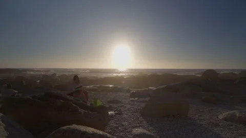 People Sunbathing at Saunders Rock Beach in Seapoint, Cape Town | Rec. 709 Video stock 308464115