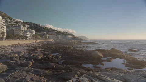 People Sunbathing at Saunders Rock Beach in Seapoint, Cape Town | Rec. 709 Stock Footage 308464387