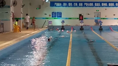 People swim in the natatorium to exercise Stock Footage 153343987