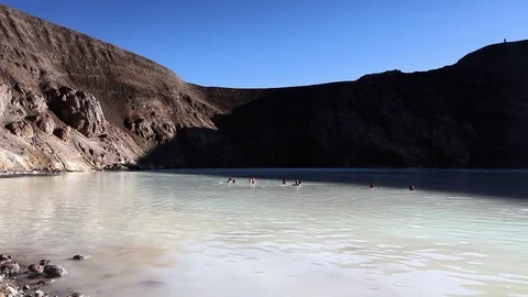 People swim into a vulcan crater Stock Footage 84681853