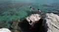People swimming near reefs rock in Mediterranean sea, Syprus HD Footage