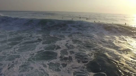 People Swimming in Ocean at Sunrise Stock Footage