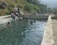 People swimming in outdoor pool at mud spa SD Footage