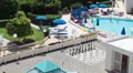 People swimming in pools and sunbathing on hotel area in Cyprus resort HD Footage