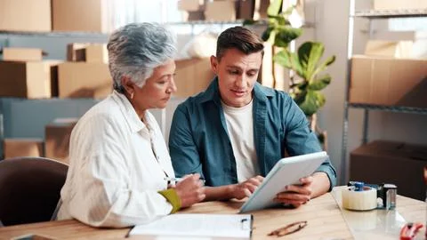 People, tablet and conversation in workshop for logistics, supply chain or Stock Photos