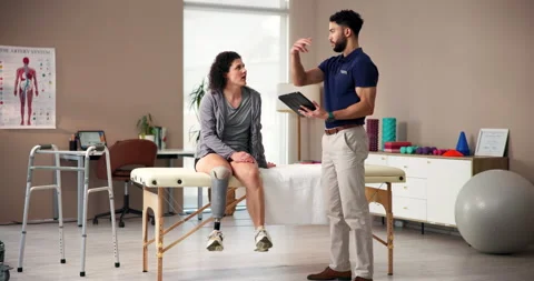 People, tablet and physiotherapy with prosthetic leg as amputee at wellness Stock Footage 283603346