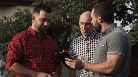 People with tablet in garden Stock Footage