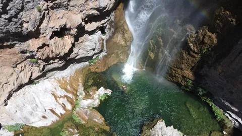 People take a bath under a waterfall during summer aerial drone view 動画素材 279569065