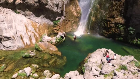 People take a bath under a waterfall during summer aerial drone view 動画素材 279569091