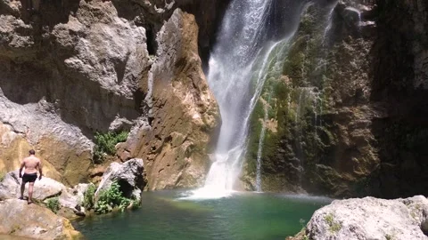 People take a bath under a waterfall during summer aerial drone view 動画素材 279569952