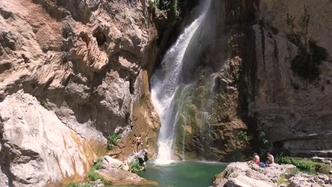 People take a bath under a waterfall during summer aerial drone view 動画素材 279570613