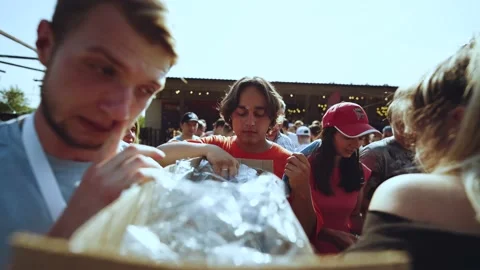 People take clothes out of the box, distributing clothes Vídeo Stock 204150313