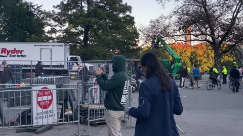 People take photos along barriers to the entry to the 50th NYC Marathon Video stock 166328967