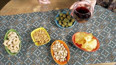 People taking glass of wine from table with appetizer and snacks slow motion Stock Footage 89847486