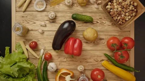 People taking simultaneously vegetables from table Stock Footage 121645153
