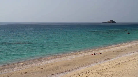 People taking the sun on a splendid beach Stock Footage 24737134