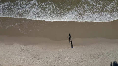 People Taking A Walk On A Sandy Beach While Social Distancing Aerial Shot Stock Footage 143852932