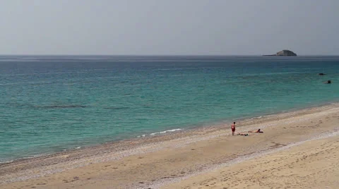 People talking and sunbathing on a splendid beach Stock Footage 24735943