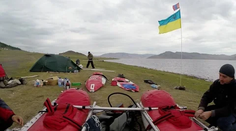 People Talking at the Red Boat on a Background of the Campground With a Stock Footage 61175202