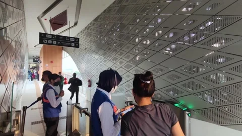 People tapping cards to enter the LRT Jabodebek station. Stock Footage 262603718