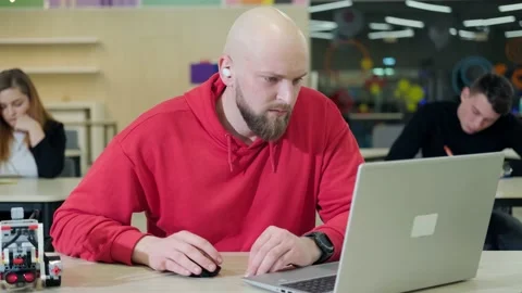 People at te robotics lessons, writting important things and trying to do the Stock Footage 155761958