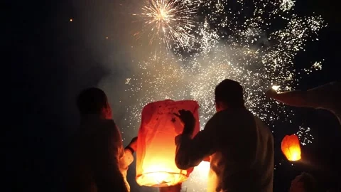 People with their backs to the camera are watching fireworks Stock Footage 163725844
