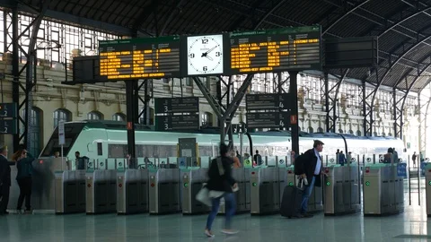 People as they pass by the security gates in the trainstation in Valencia Stock Footage 88501443