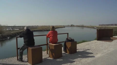 People thinking sitting in front of Comacchio lagoon. Peaceful atmosphere. Stock Footage 213654785
