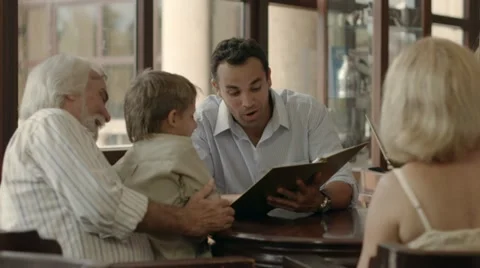 People from three generations ordering meal in restaurant Stock Footage 11159813
