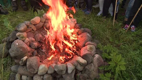 People throw grain into fireplace flame Stock Footage 104866245