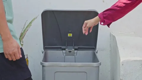 People throwing broken smartphone screens and circuit boards into dedicated Stock Footage 340575893