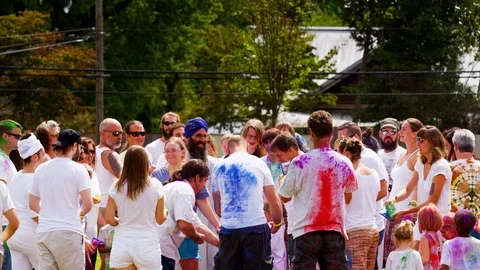 People throwing colored powder at each other during powder ceremony Stock Footage 102243477