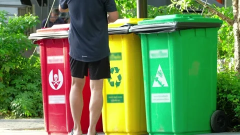 People throwing some garbage into a recycle bin Stock Footage 249731509