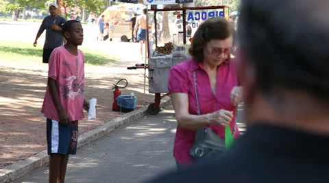 People tip poor singing boy at Porto Alegre's Flea Market (FleaMkt 48) Video stock 23750119