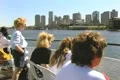 People on tour boat looking at city and listening to tour guide Footage